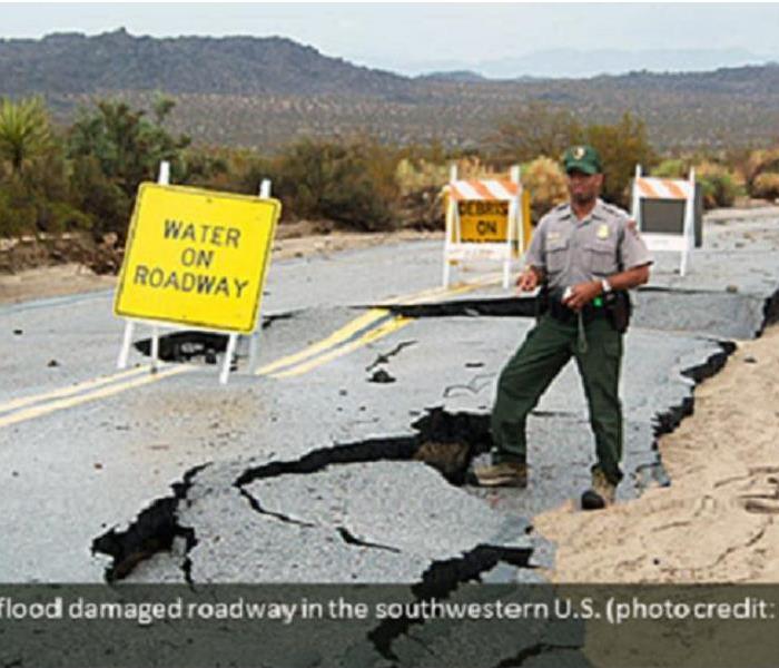 Damage to a road from a flood in southwestern United States
